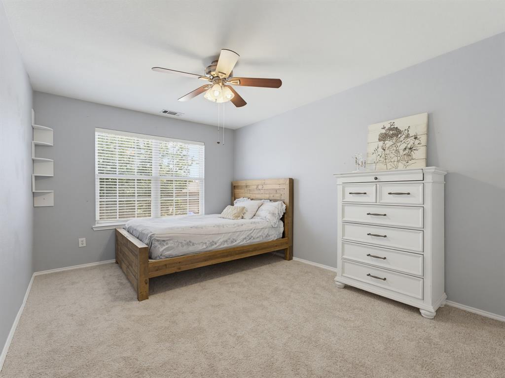 13268 Fencerow Road Fort Worth, TX 76244 - Photo 17 of 25 Carpeted room featuring a ceiling fan with integrated lighting, a window with blinds, and white wall shelving
