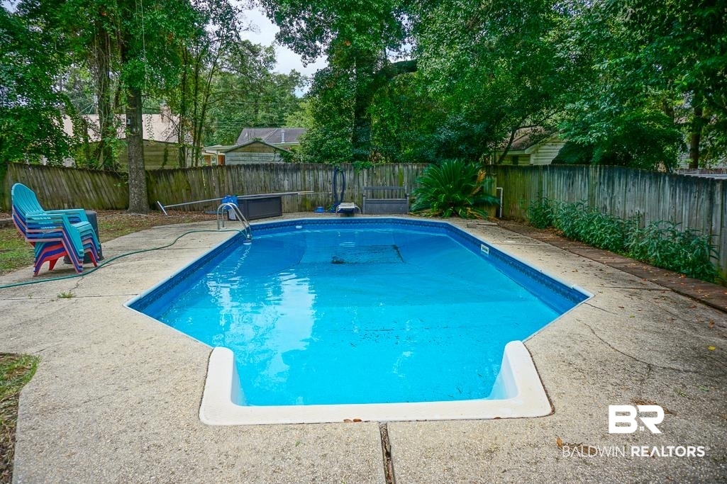 254 Thrift Street Mobile, AL 36609 - Photo 16 of 16 View of swimming pool featuring a fenced backyard and a patio