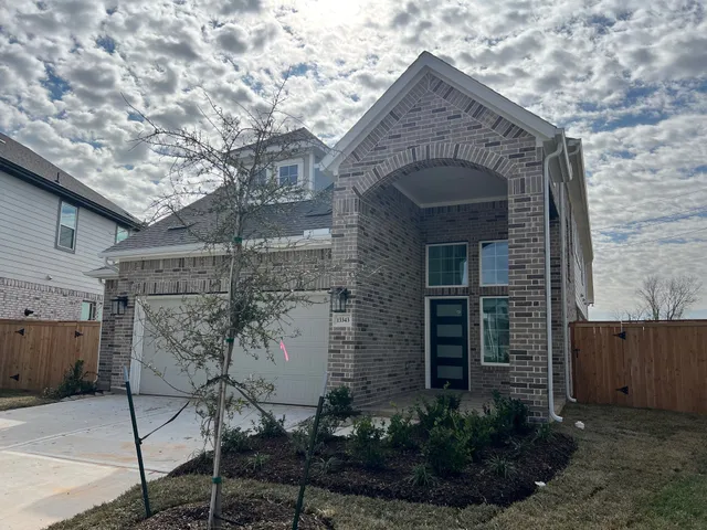 a stone house with a tree in front of it