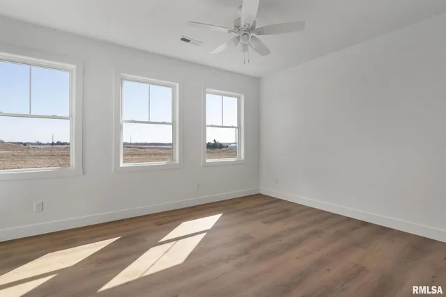 a view of a room with wooden floor and bedroom view