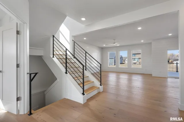 a view of entryway and hall with wooden floor