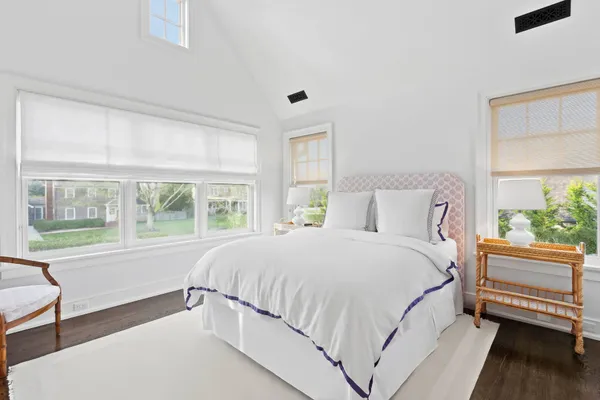 a bedroom with a large bed and a large window