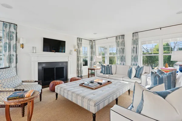 a living room with furniture a table and a fireplace