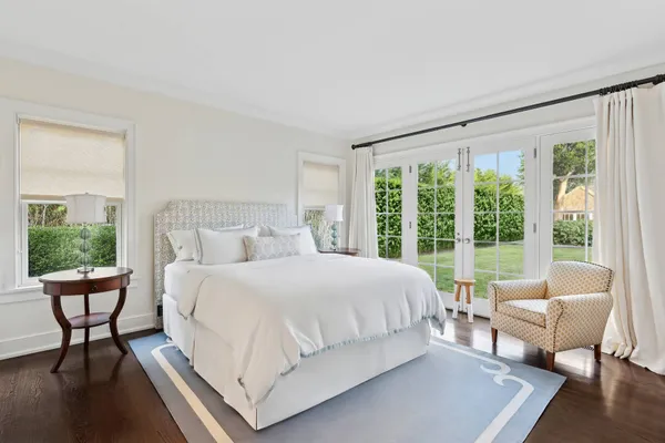 a bedroom with a bed and a lounge chair