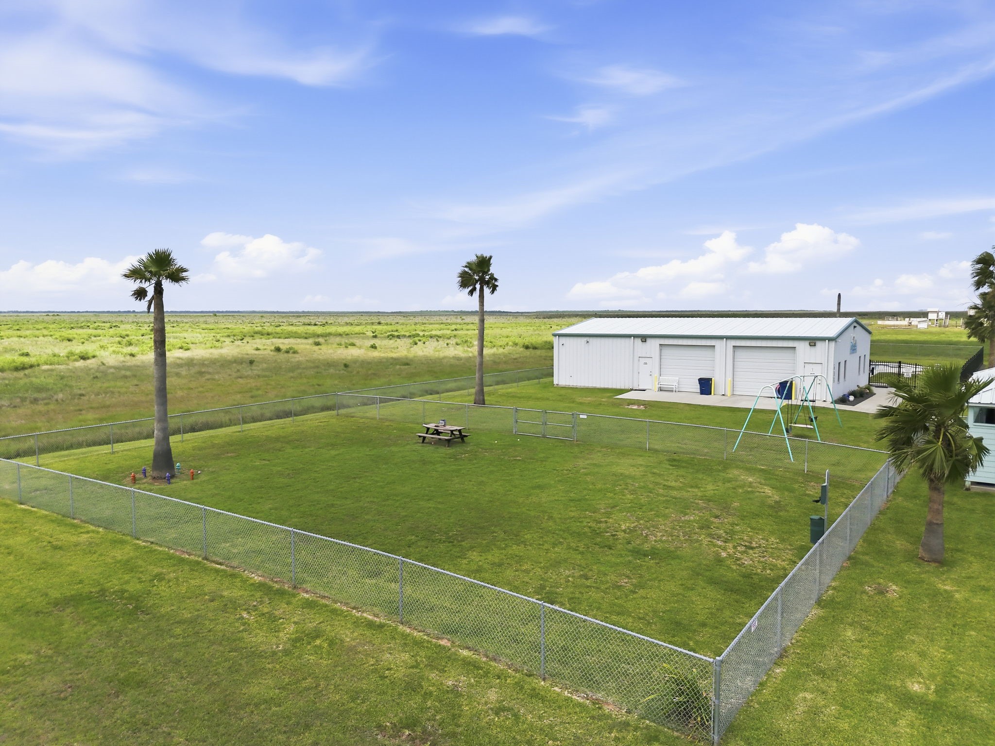 119 Sand Shoals Road Freeport, TX 77541 - Photo 29 of 34 Hide-A-Way on the Gulf community amenity — fenced dog park with picnic table, and clubhouse building included with HOA membership.