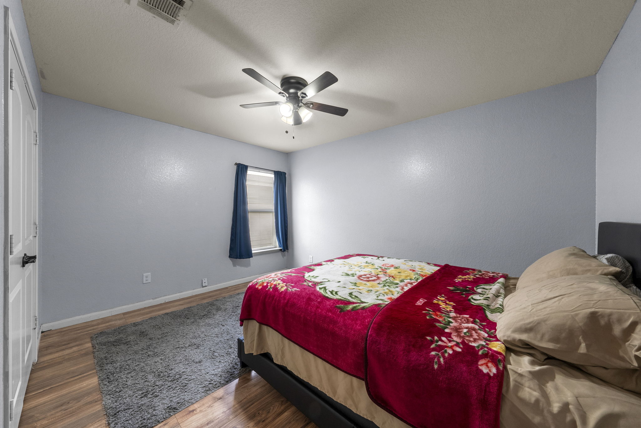 1617 Treeta Trail Kyle, TX 78640 - Photo 23 of 39 a bedroom with a bed and a chandelier