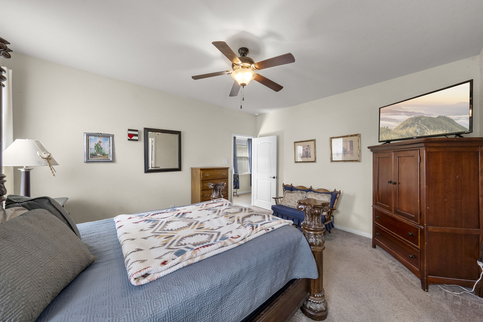1617 Treeta Trail Kyle, TX 78640 - Photo 27 of 39 a bedroom with furniture and a ceiling fan
