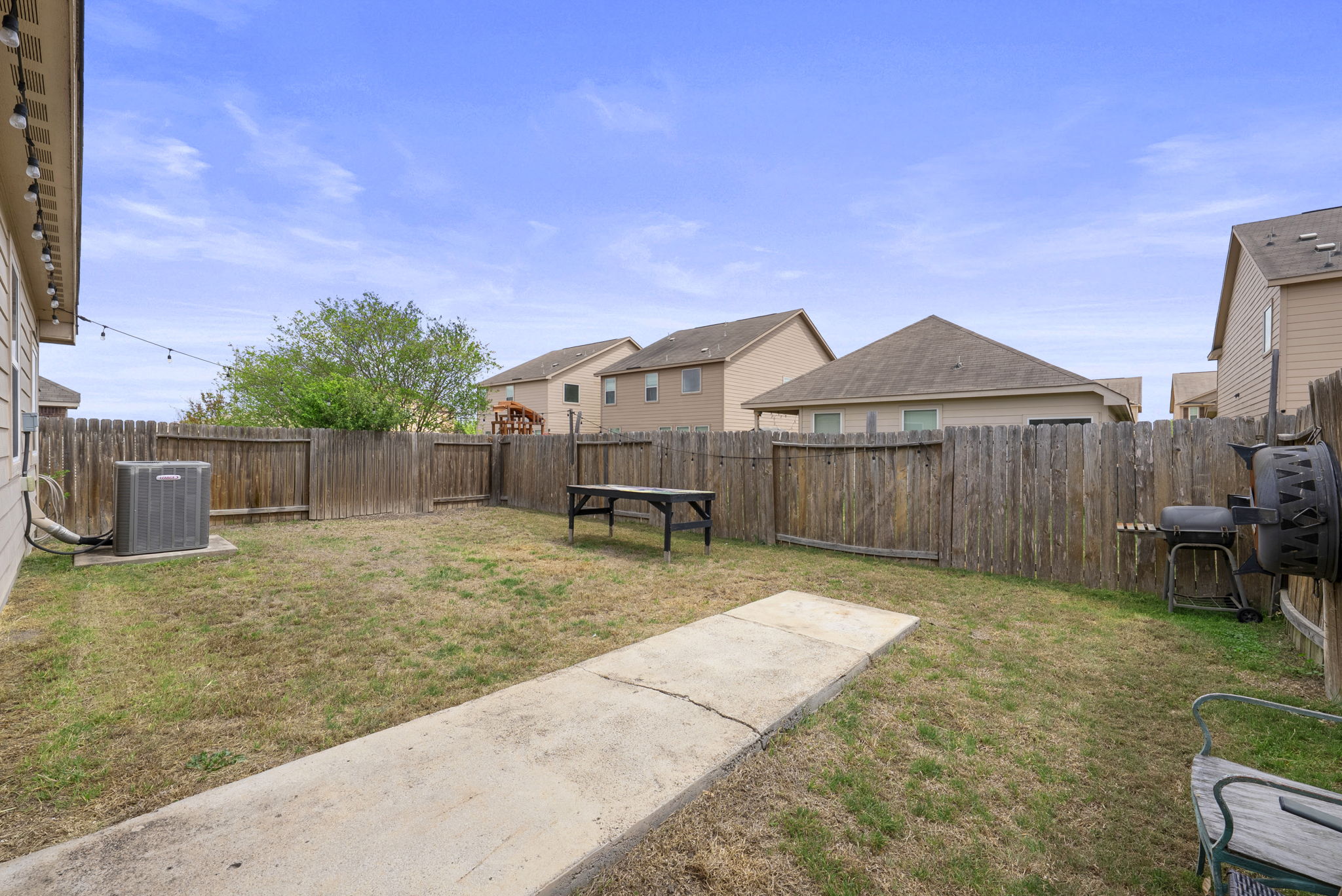 1617 Treeta Trail Kyle, TX 78640 - Photo 33 of 39 a backyard of a house with table and chairs