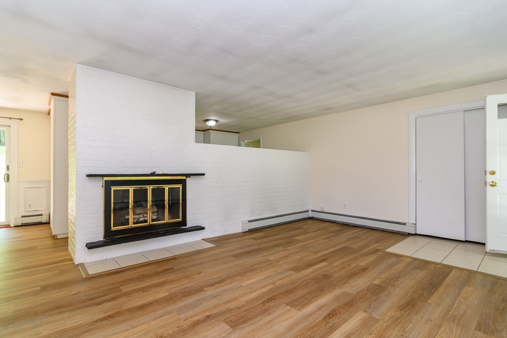 33 Eisenhower Road Framingham, MA 01701 - Photo 5 of 20 a view of an empty room with wooden floor and a window