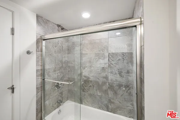 a bathroom with a glass shower door