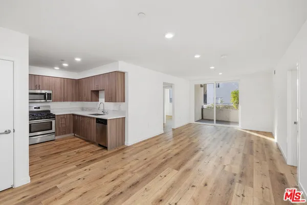 a large kitchen with a center island and a counter top space