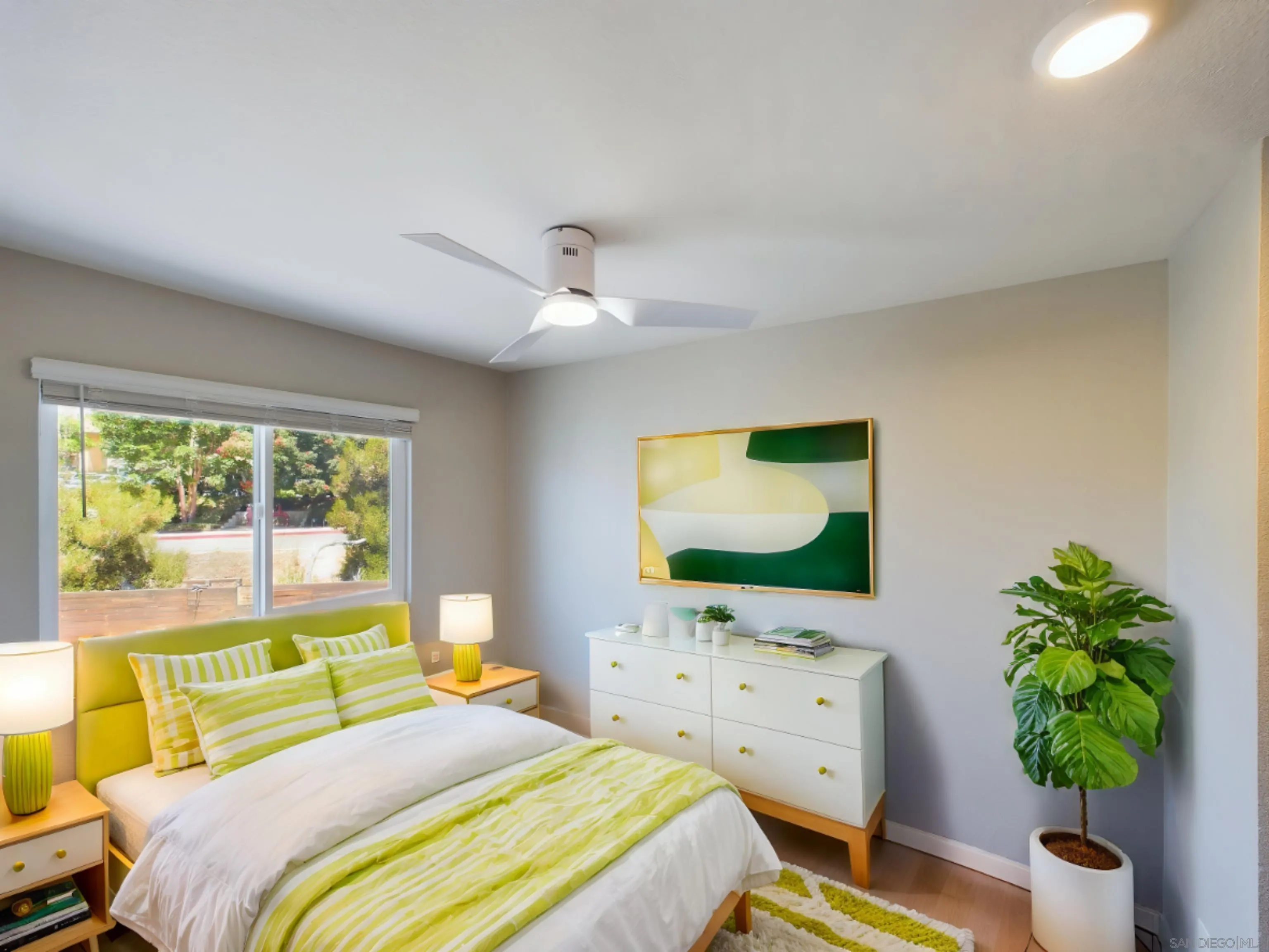 185 Saxony Road Encinitas, CA 92024 - Photo 12 of 14 a bedroom with a bed table and flat screen tv