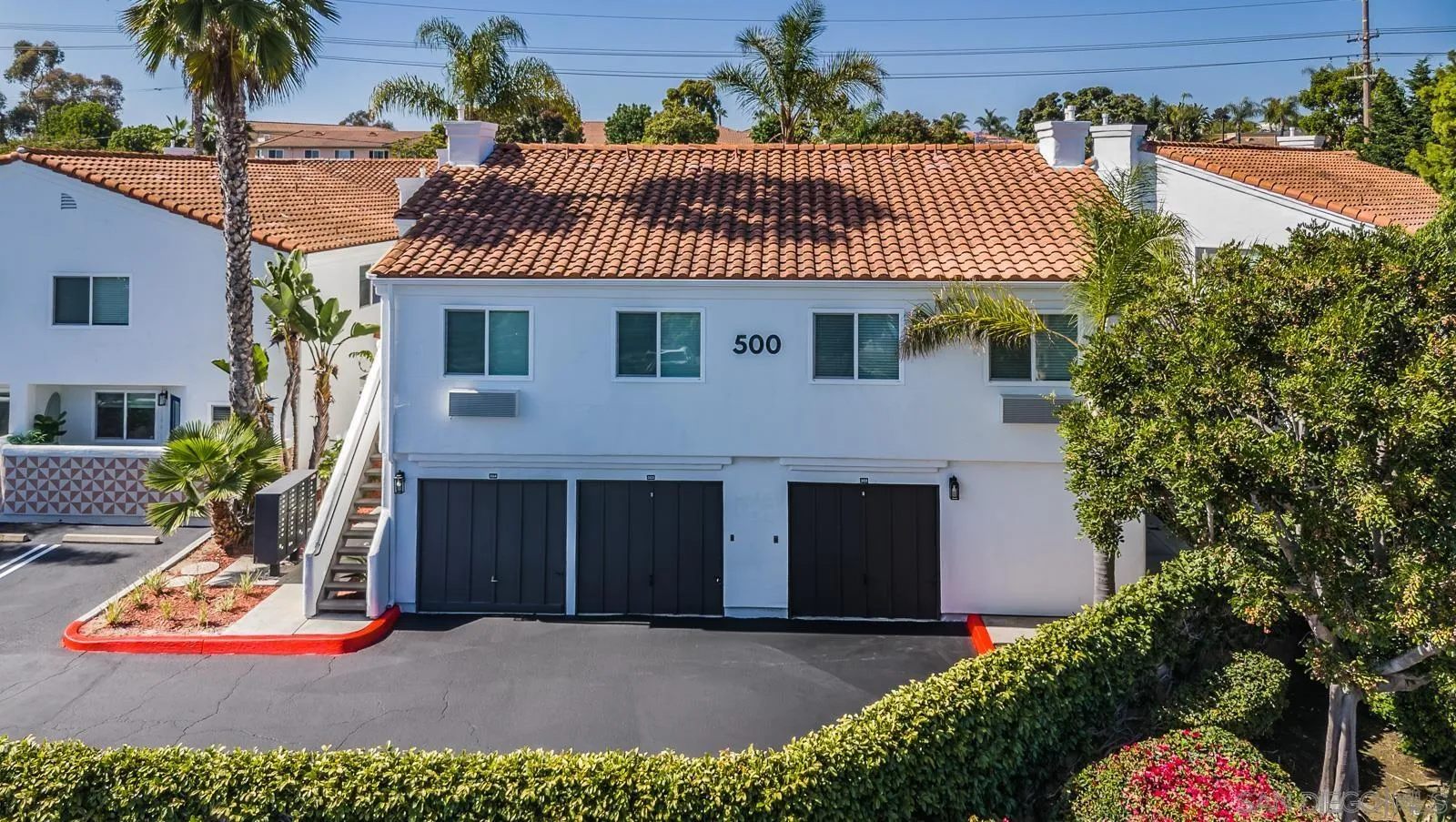 185 Saxony Road Encinitas, CA 92024 - Photo 2 of 14 a front view of a house with a garage