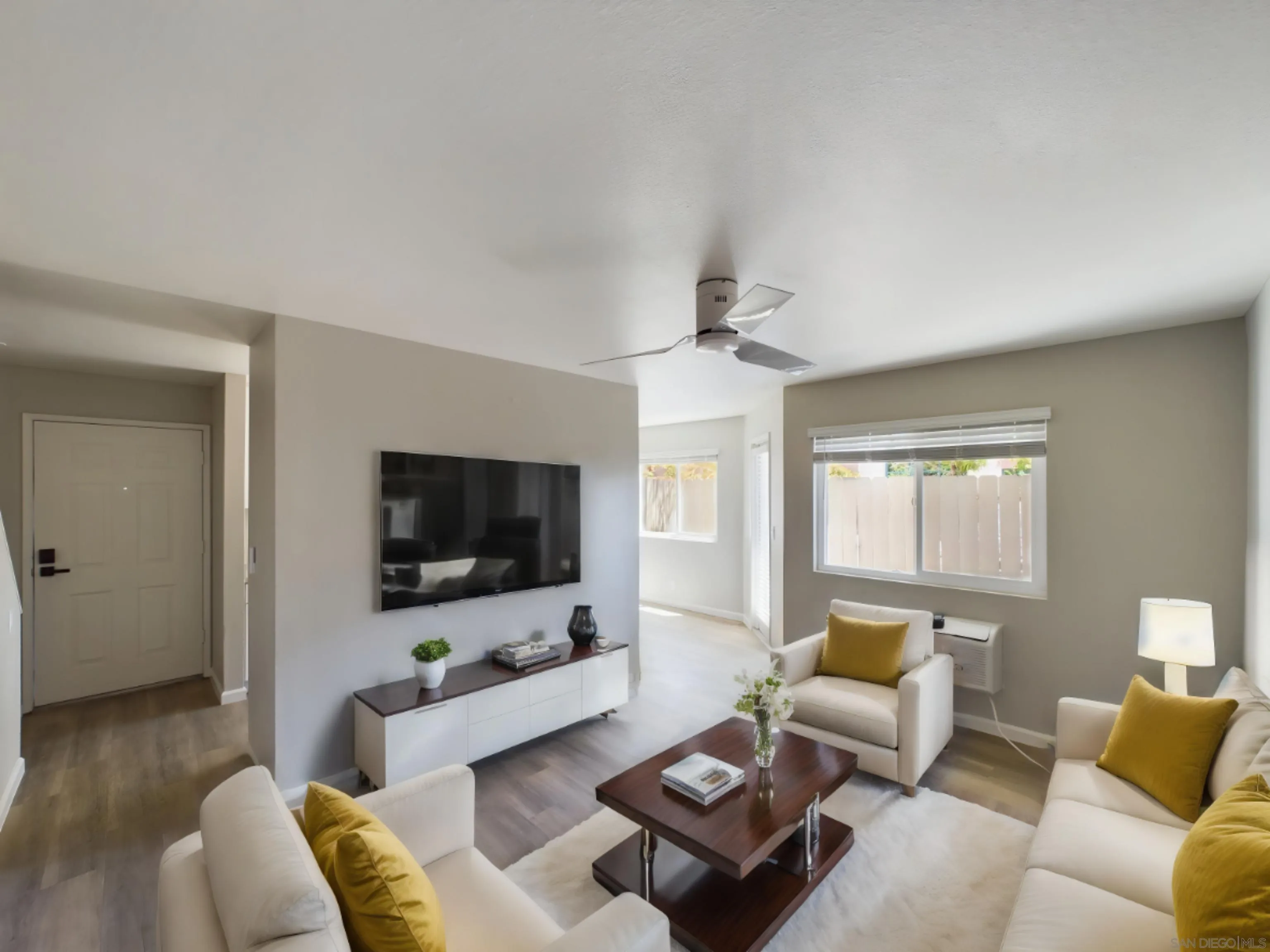 185 Saxony Road Encinitas, CA 92024 - Photo 9 of 14 a living room with furniture and a flat screen tv