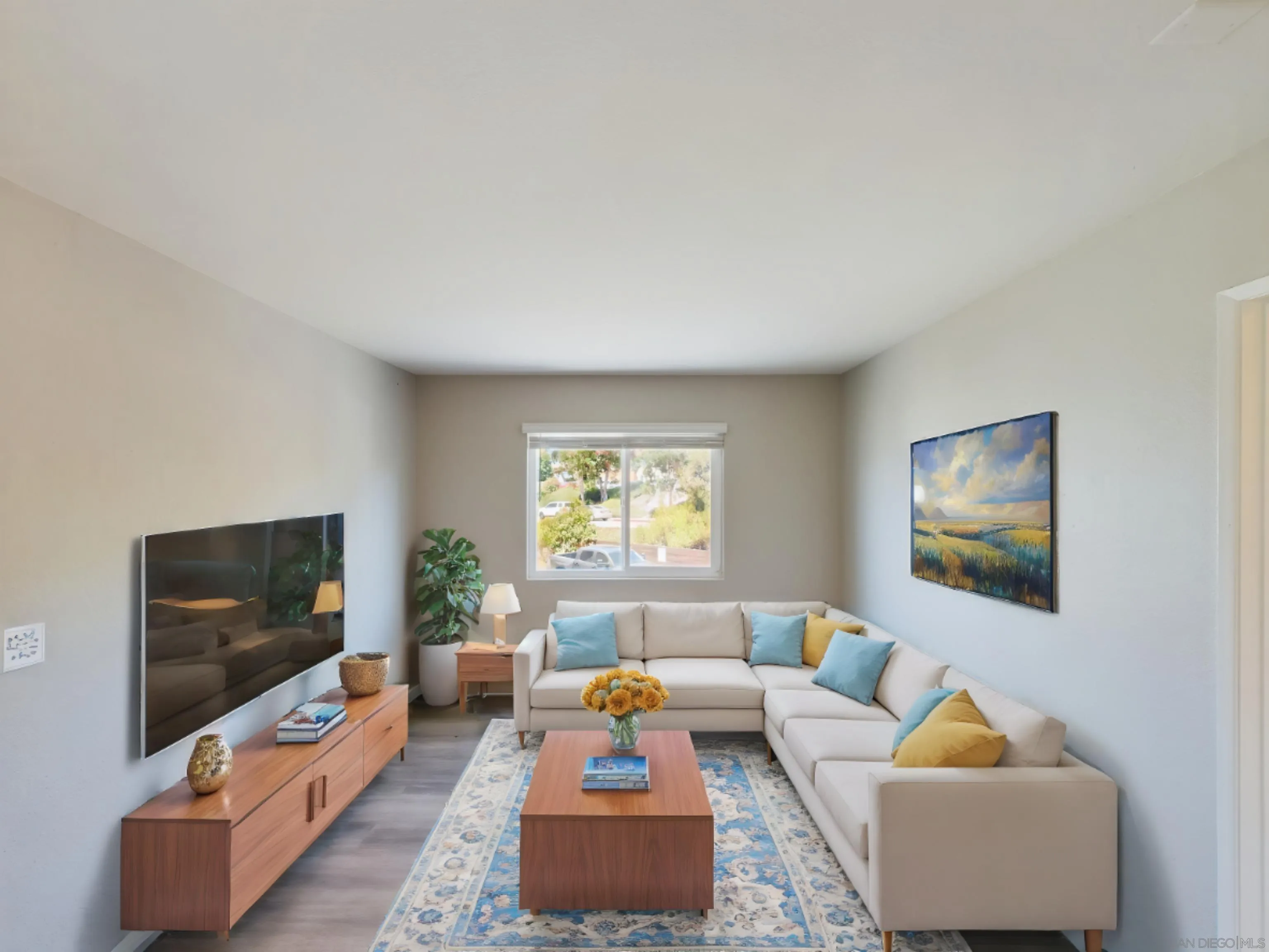 185 Saxony Road Encinitas, CA 92024 - Photo 10 of 14 a living room with furniture and a flat screen tv
