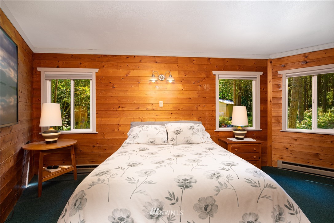 3625 Green Cliffs Road Anacortes, WA 98221 - Photo 17 of 26 a bedroom with a bed and wooden floor