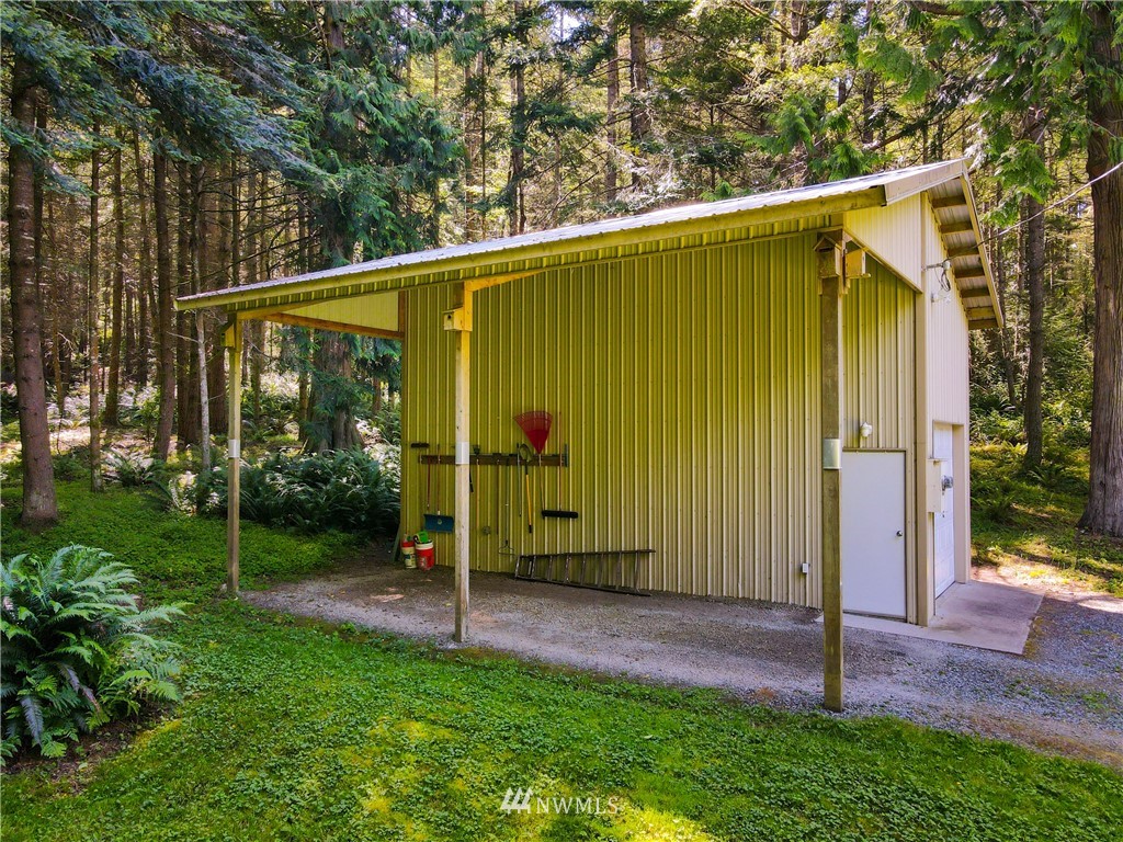 3625 Green Cliffs Road Anacortes, WA 98221 - Photo 6 of 26 a view of a house with backyard and a tree