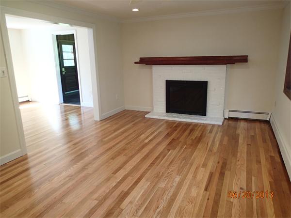 100 Cordaville Road Ashland, MA 01721 - Photo 5 of 11 a view of an empty room with wooden floor and a fireplace