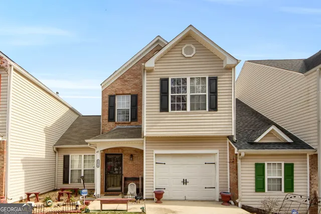 a front view of a house with a garage