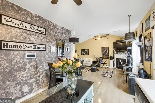 a view of a dining room with furniture and chandelier