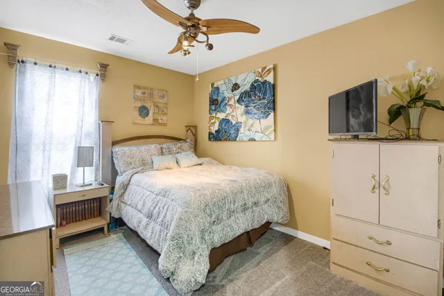 a bathroom with a sink a toilet and shower curtain