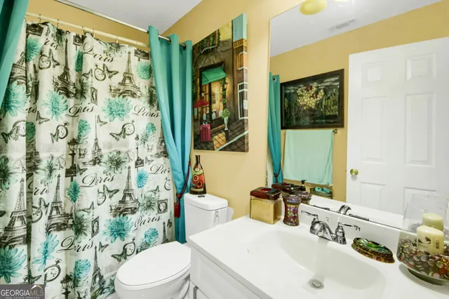 a patio with table and chairs and potted plants