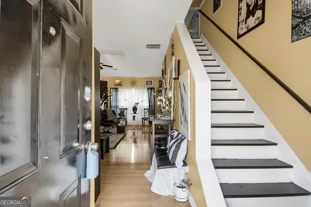 a view of entryway and hall with wooden floor