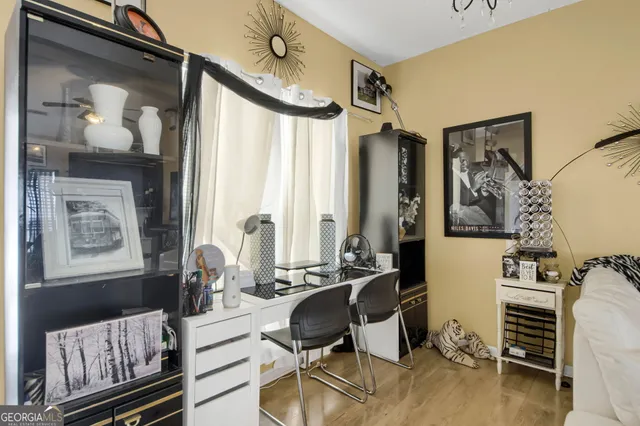 a living room with furniture and a painting on the wall