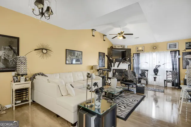 a living room with furniture and wooden floor