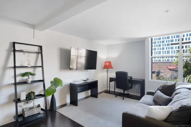 a living room with furniture and a flat screen tv