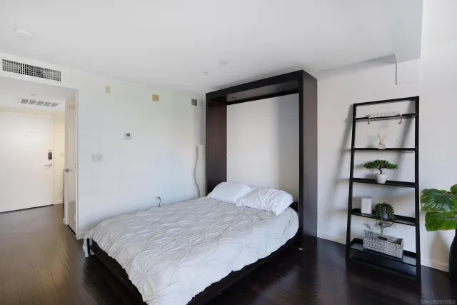 a kitchen with refrigerator and kitchen island