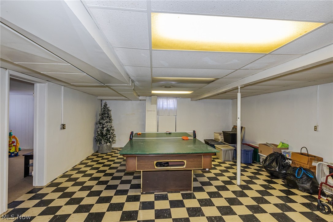 180 South Leavitt Road Amherst, OH 44001 - Photo 30 of 37 Recreation room with dark flooring and a paneled ceiling