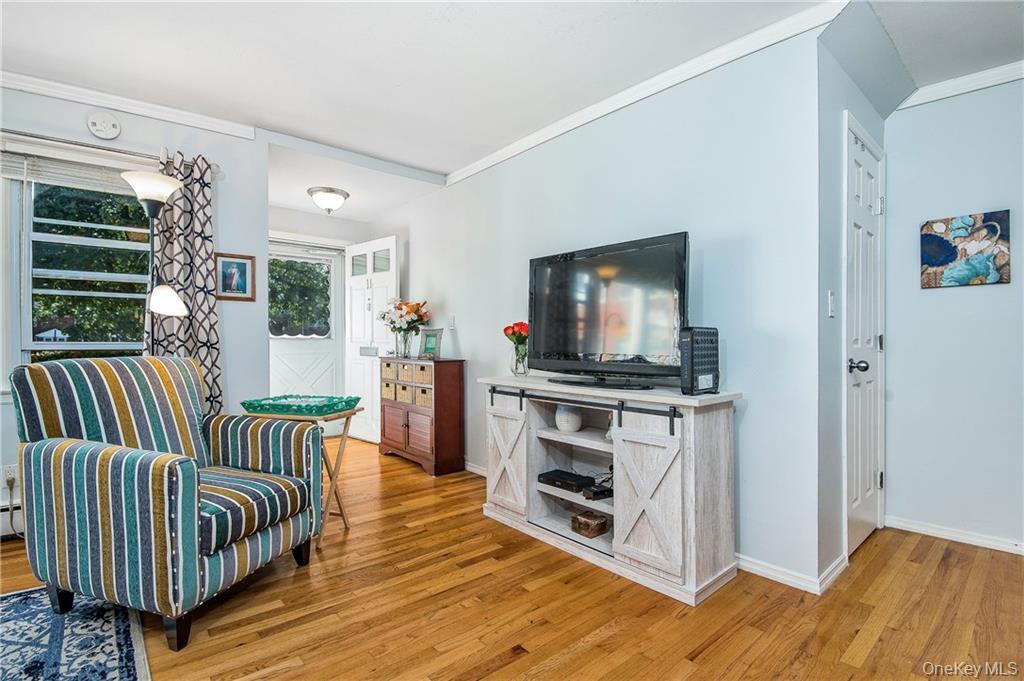 2710 South Road, Unit F11 Poughkeepsie, NY 12601 - Photo 3 of 10 a living room with furniture and a flat screen tv