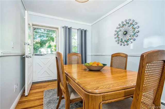 a dining room with furniture and wooden floor