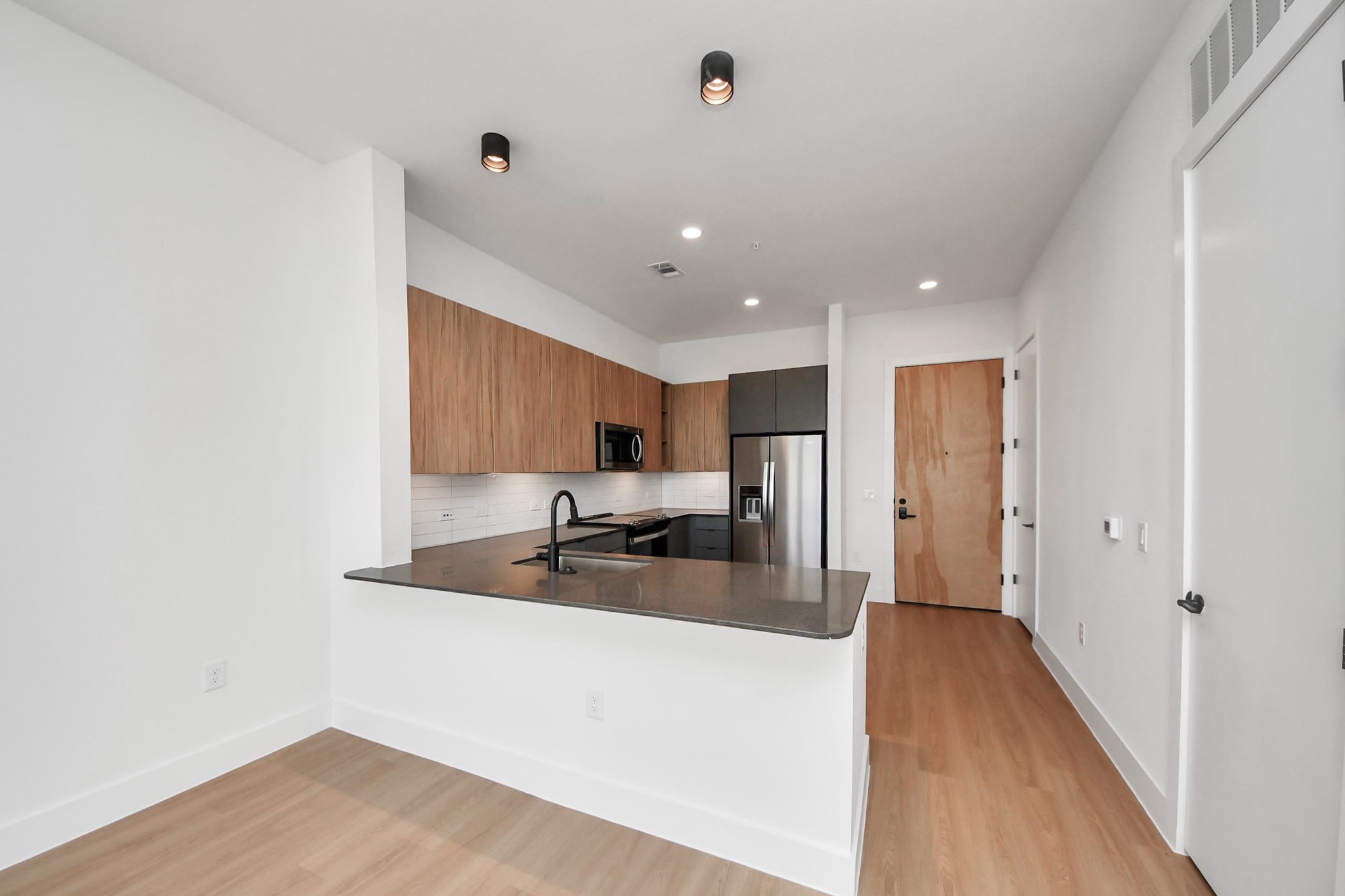 2810 Riverby Road, Unit 119 Houston, TX 77020 - Photo 12 of 38 a view of a kitchen with a sink and a refrigerator
