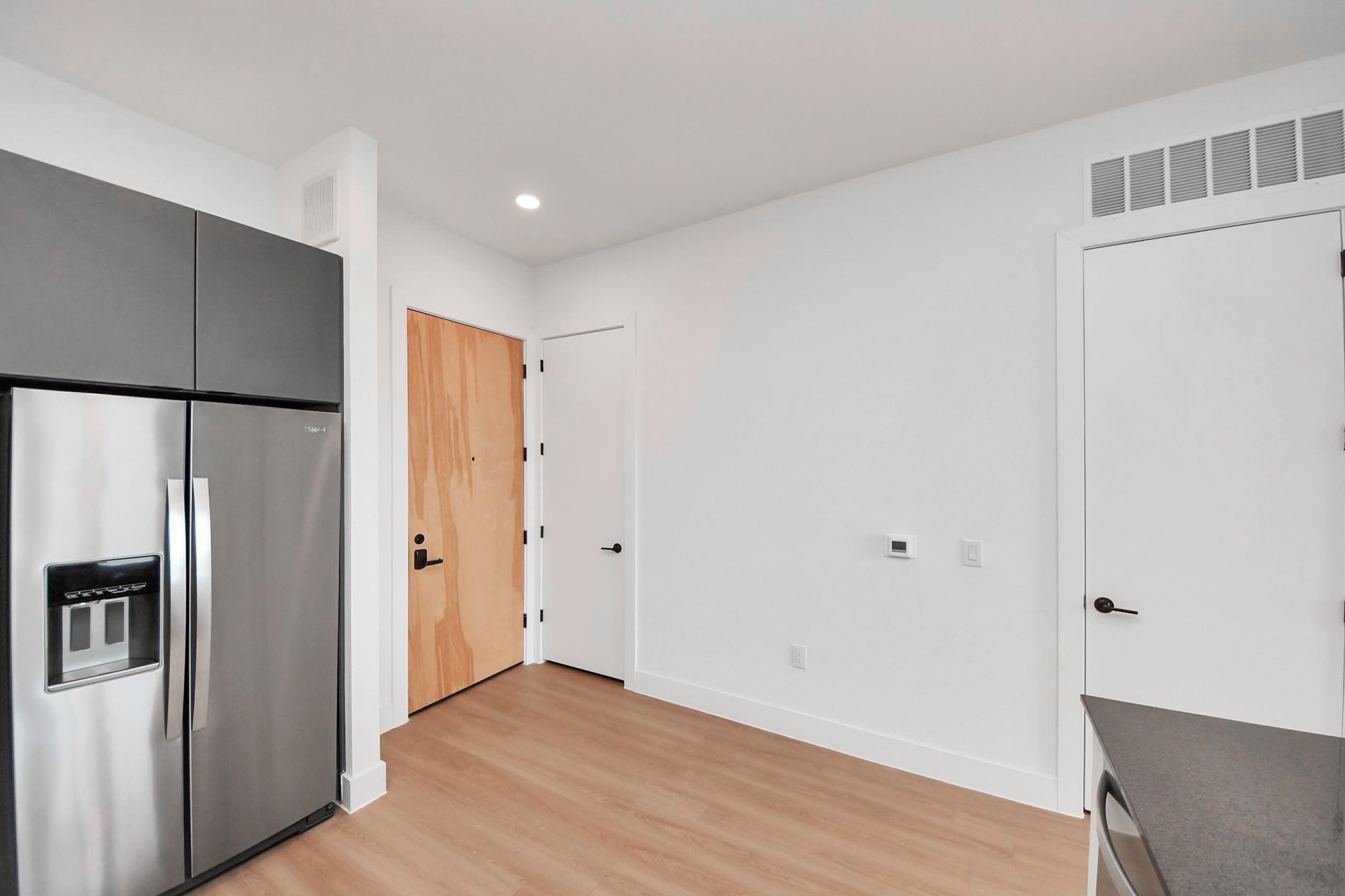 2810 Riverby Road, Unit 119 Houston, TX 77020 - Photo 7 of 38 a view of a kitchen with a refrigerator and wooden floor