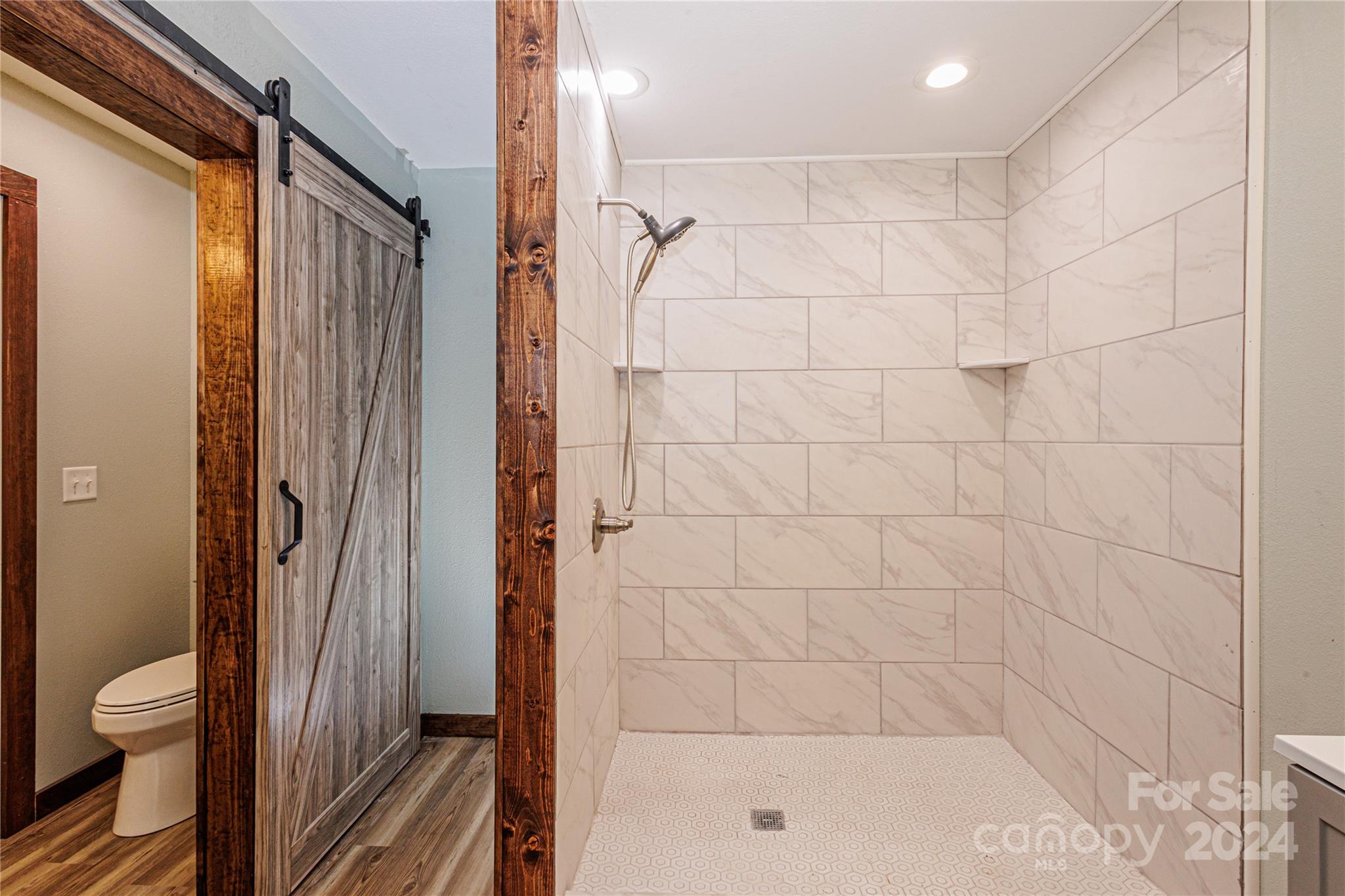 1233 Bryson Branch Road Bryson City, NC 28713 - Photo 11 of 28 a bathroom with a shower and a toilet