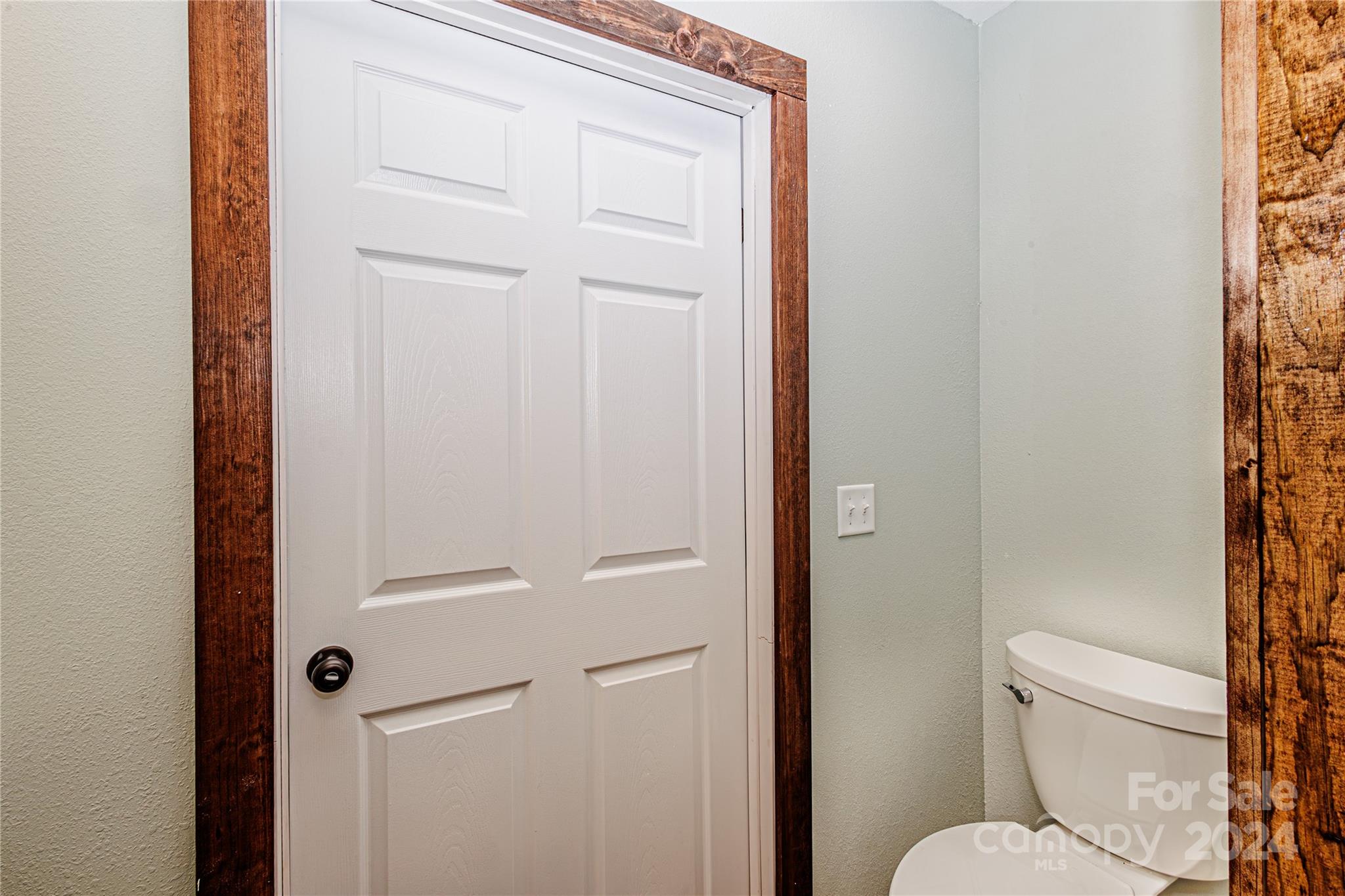 1233 Bryson Branch Road Bryson City, NC 28713 - Photo 13 of 28 a white toilet sitting next to a shower curtain