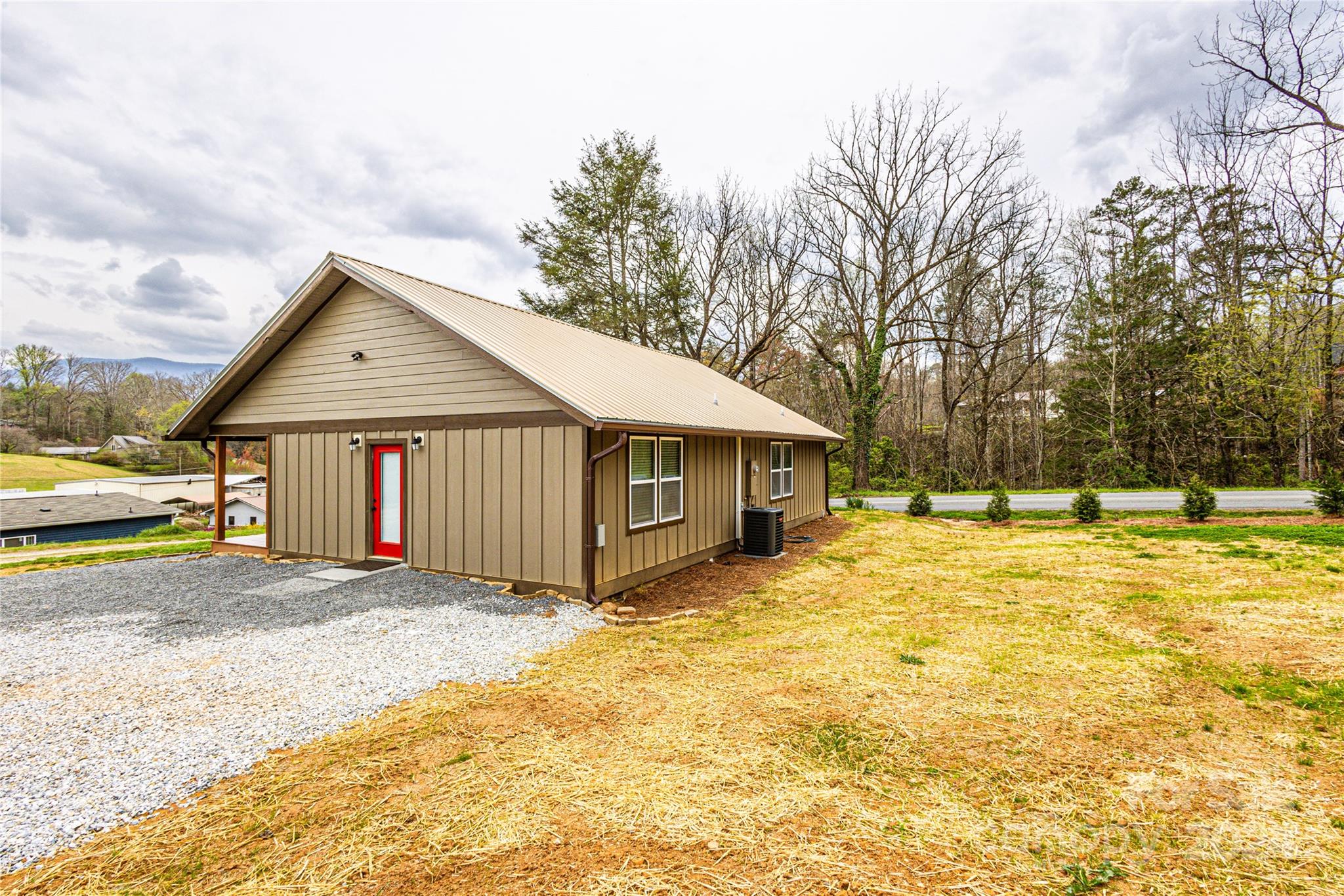 1233 Bryson Branch Road Bryson City, NC 28713 - Photo 21 of 28 a front view of a house with a yard and garage