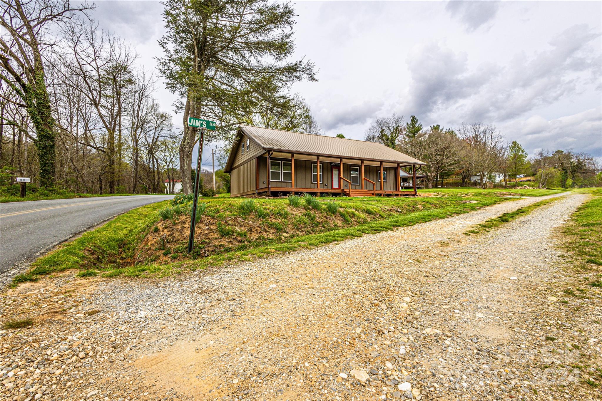 1233 Bryson Branch Road Bryson City, NC 28713 - Photo 24 of 28 a front view of a house with a yard and trees