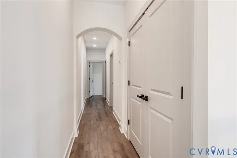 a view of a hallway with wooden floor