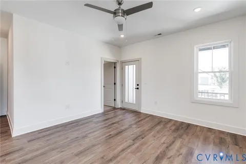 wooden floor in an empty room with a window
