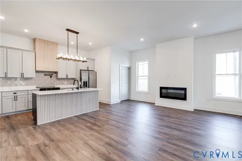 a large kitchen with kitchen island a sink stainless steel appliances and cabinets
