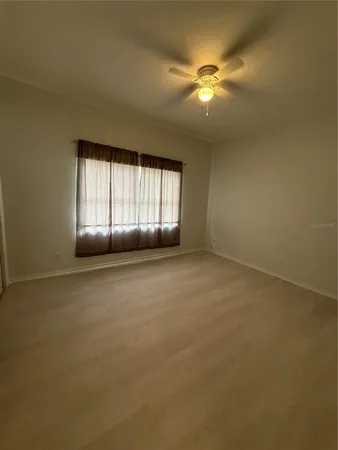 an empty room with a fireplace and windows