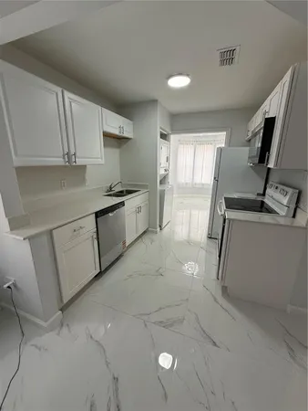 a kitchen with a sink and cabinets