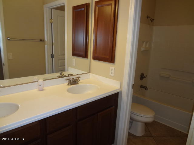 6837 West Carson Road Laveen, AZ 85339 - Photo 15 of 21 a bathroom with a sink a toilet and shower