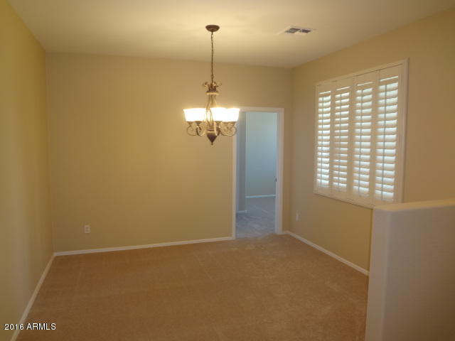 6837 West Carson Road Laveen, AZ 85339 - Photo 4 of 21 a view of a room with windows and chandelier