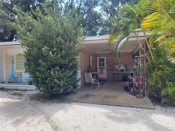a backyard of a house with outdoor seating and trees