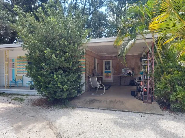 a backyard of a house with outdoor seating and trees