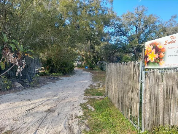 a view of a yard with wooden fence